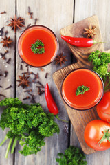 Tomato juice in glasses and fresh vegetables