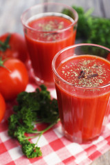 Tomato juice in glasses and fresh vegetables