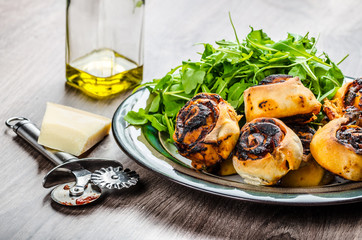 Pizza snails, minipizza with salad and parmagio