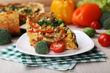 Piece of Vegetable pie with broccoli, peas, tomatoes and cheese