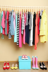Colorful clothes and shoes in room