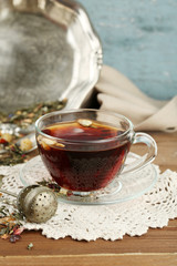 Beautiful vintage composition with herbal tea, on wooden table
