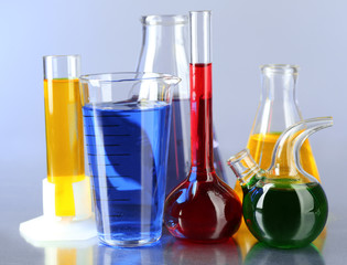 Different laboratory glassware with colorful liquid