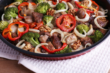 Braised wild mushrooms with vegetables and spices in pan