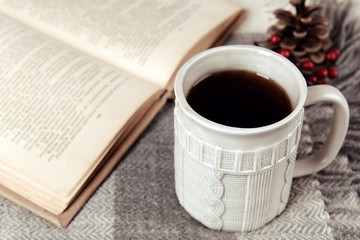 Naklejka na ściany i meble Cup of tea with book on table close-up