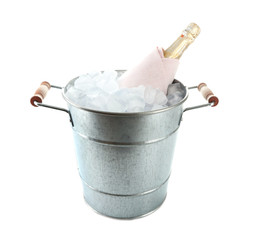 Bottle of champagne in metal ice bucket isolated on white