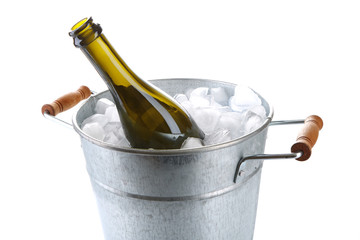Bottle of champagne in metal ice bucket isolated on white