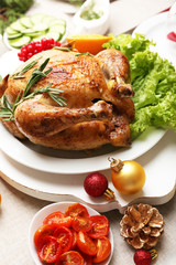 Baked chicken for festive dinner. Christmas table setting