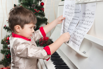 Boy playing the piano on Christmas Eve