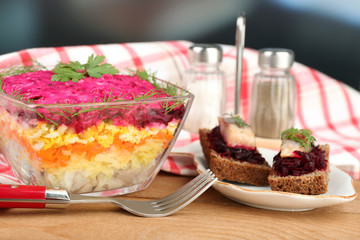 Russian herring salad in glass bowl