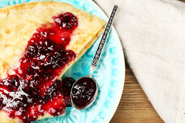 Plate of delicious pancakes with berry jam