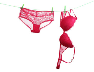 Woman panties and bra hanging on rope isolated on white