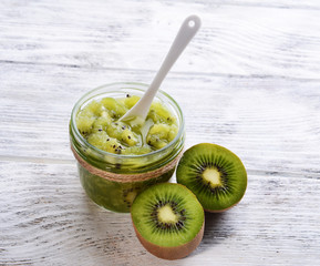 Delicious kiwi jam on table close-up