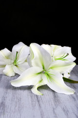 Fototapeta na wymiar Beautiful lily on wooden table