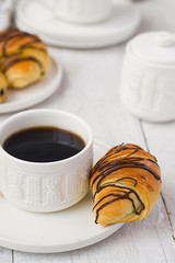 Puff pastry rolls with chocolate and coffee cup