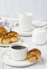 Puff pastry rolls with chocolate and coffee cup