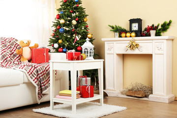 Beautiful Christmas interior with decorative fireplace and fir