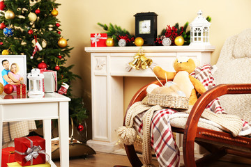 Beautiful Christmas interior with decorative fireplace and fir