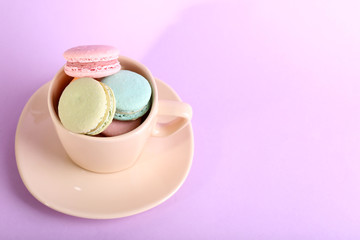 Assortment of gentle colorful macaroons in colorful mug