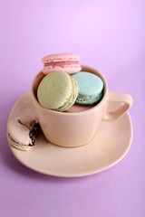 Assortment of gentle colorful macaroons in colorful mug