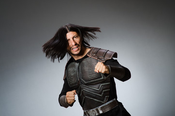 Angry warrior against dark background