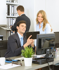 Work colleagues looking at tablet