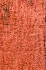 Red painted rough wooden siding board