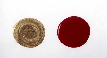 Gold and red color round shape nail varnish