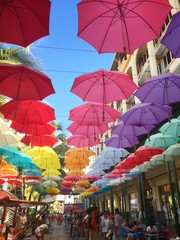 Colourful street umbrellas in Port Louis, Mauritius  - obrazy, fototapety, plakaty