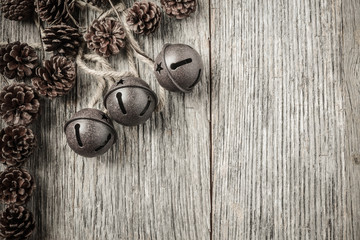Pine cones and Rustic Bells on an Old Wood Background