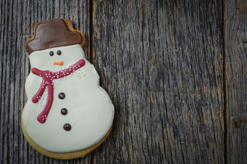 Snowman Cookie on Rustic Wood Background for Christmas