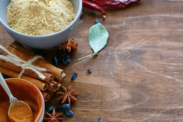 cinnamon, ginger, star anise on wooden background
