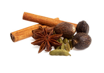 Anise, cardamom, nutmeg and cinnamon sticks on a white backgroun