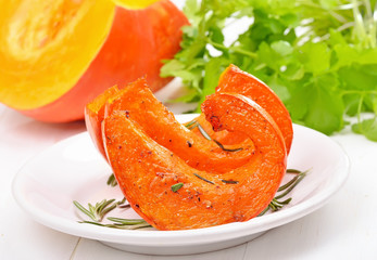 Baked pumpkin slices on white plate