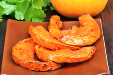 Baked pieces of pumpkin on plate