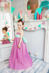 Beautiful little girl in a pink dress