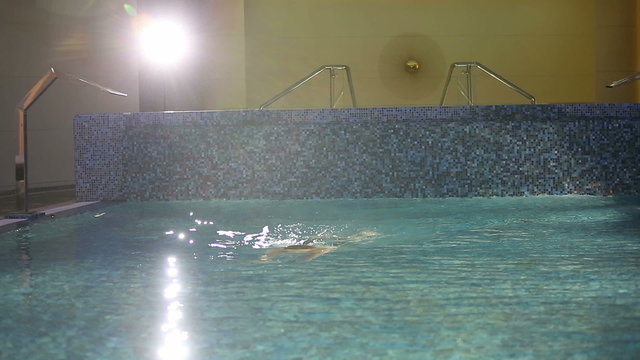The rich man is swimming in the pool. Close up