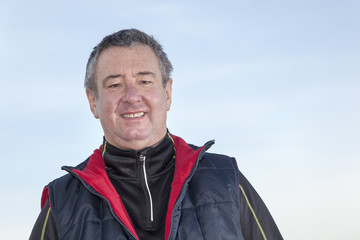 Portrait of a gray-haired man while walking