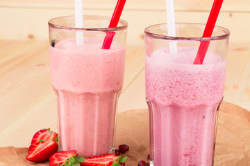 Strawberry milkshake on a wood.
