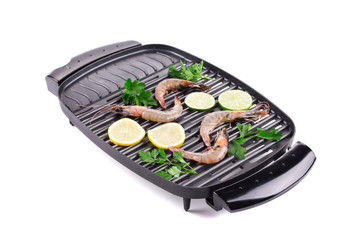 Raw shrimps on pan with lemon.