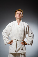 Funny karate fighter wearing white kimono