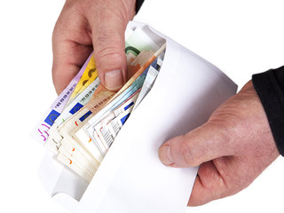Hand holding envelope with paper money