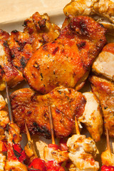 Roast chicken meat sticks on barbecue