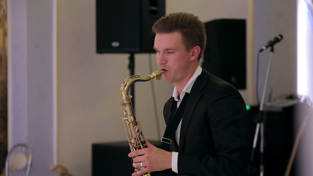 Saxophone player performs on stage.