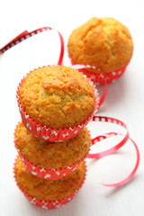 Muffins in red cups on white background