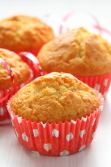 Muffins in red cups on white background