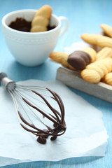 Whisk with melted chocolate and homemade shortbread cookies