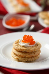 Oat bran cookies with red caviar and cream cheese