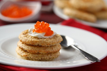 Oat bran cookies with red caviar and cream cheese