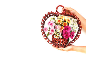 Hand holding Flower in wooden handmade basket isolated on white
